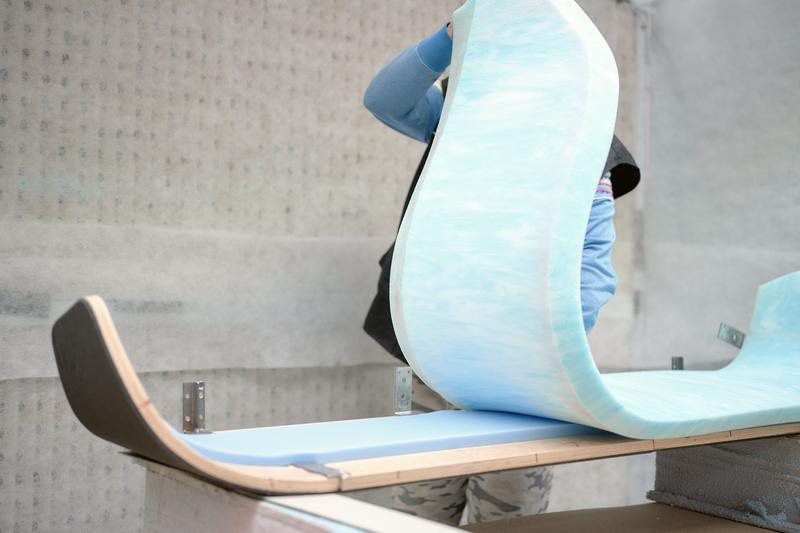 Upholstery foam being wrapped around a shell