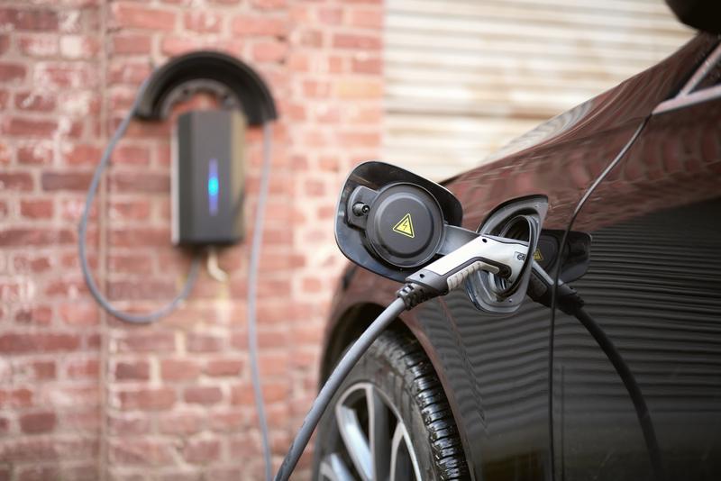 Charging station for electric cars on the brick wall of the factory