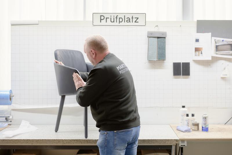 Employee inspecting a chair at final inspection